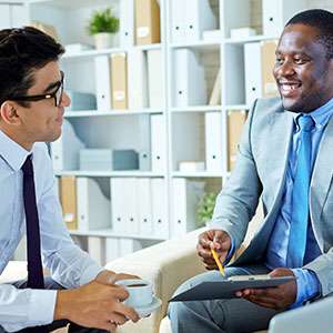 Student reading book in library wearing mask