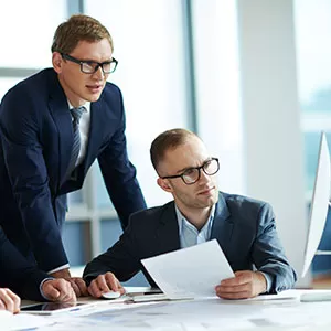 Student reading book in library wearing mask