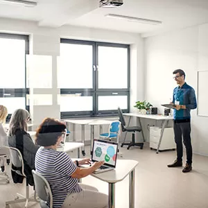 Student reading book in library wearing mask