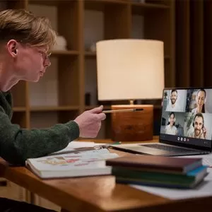 Student reading book in library wearing mask