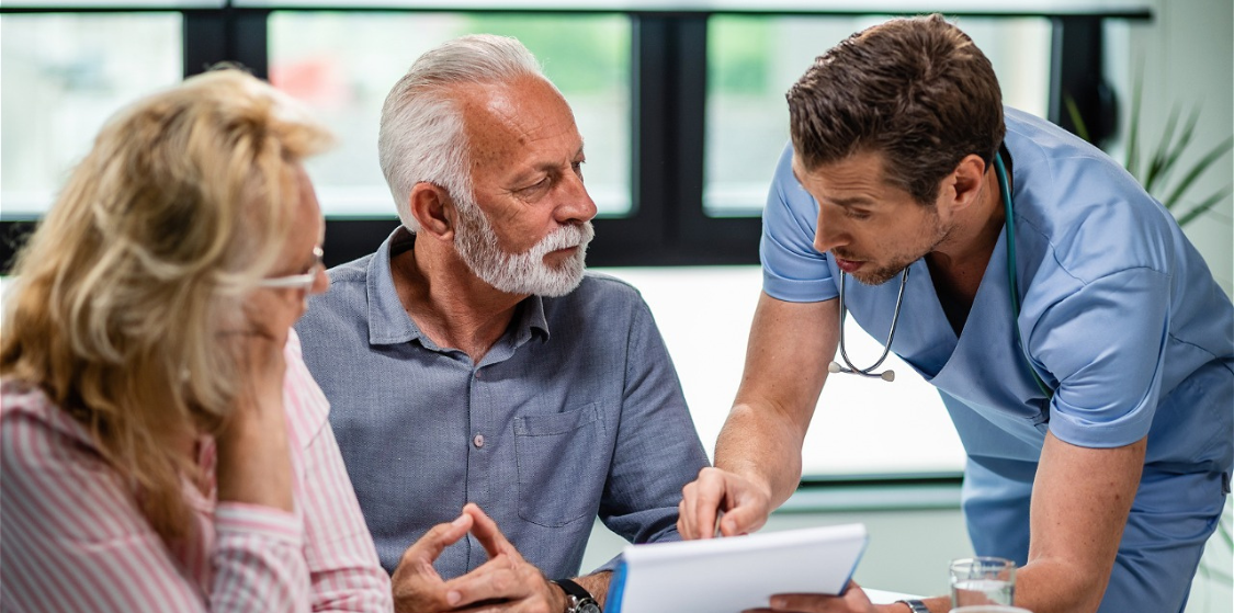 doctor-discussing-with-senior-couple-about-their-medical-documents-appointment-clinic
