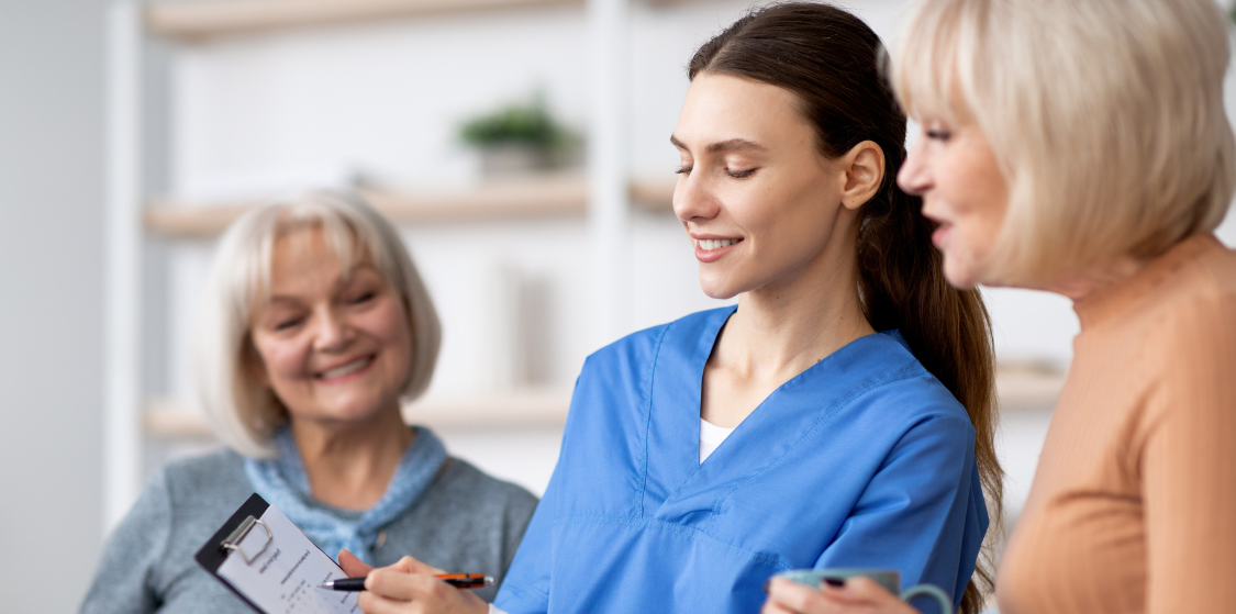 carer-guiding-elderly-women