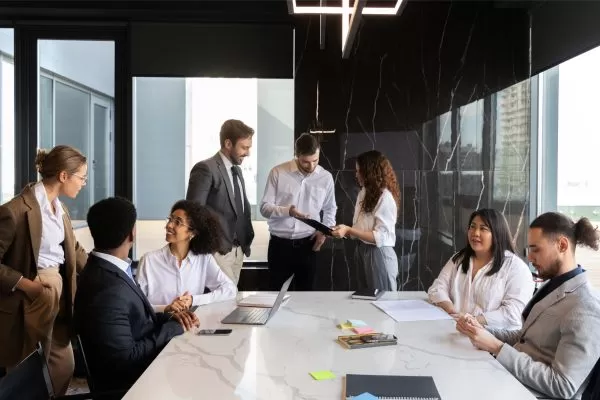 Business meeting with a man and woman discussing something on a tablet