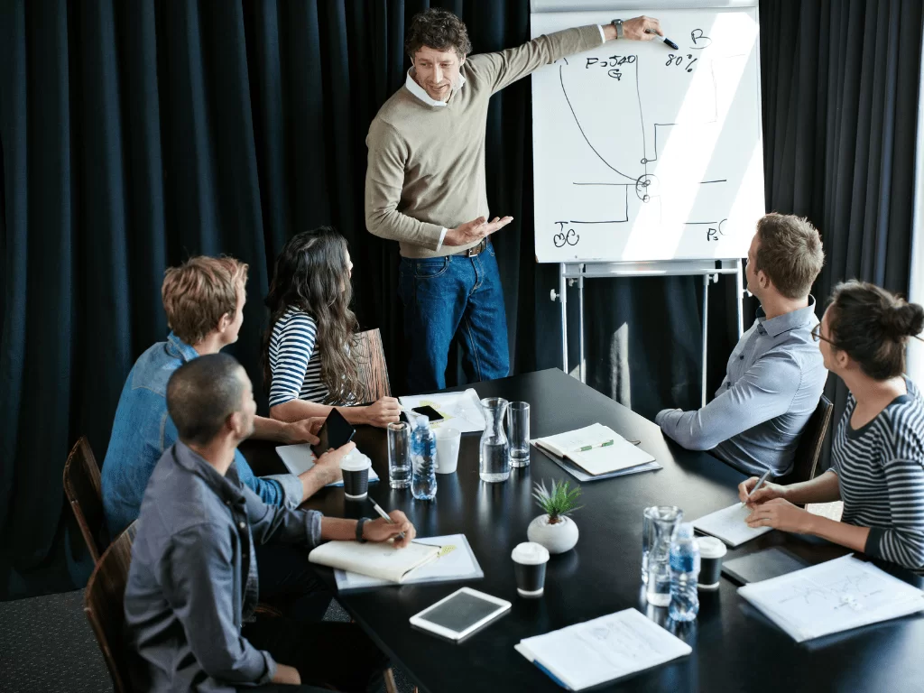 Illustration of a man in red shirt standing behind a pie chart with small human icons on it, symbolizing management and leadership